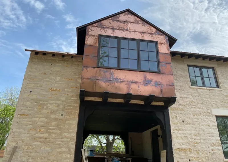 Copper metal panel facade on a stone building for Roof Repair in Stanford