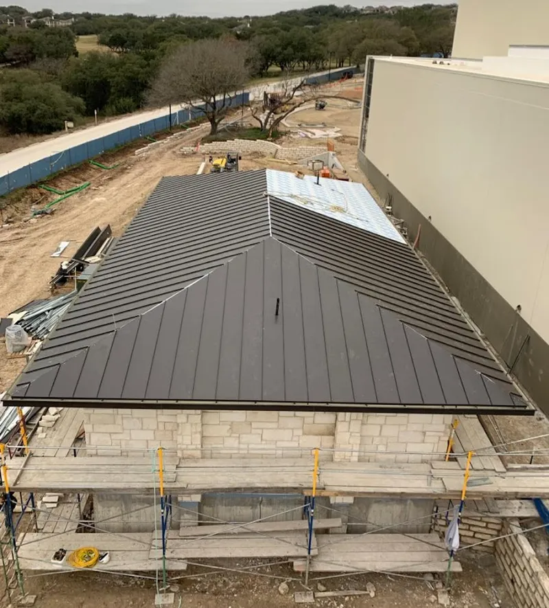Metal roof new construction with scaffolding in Stanford