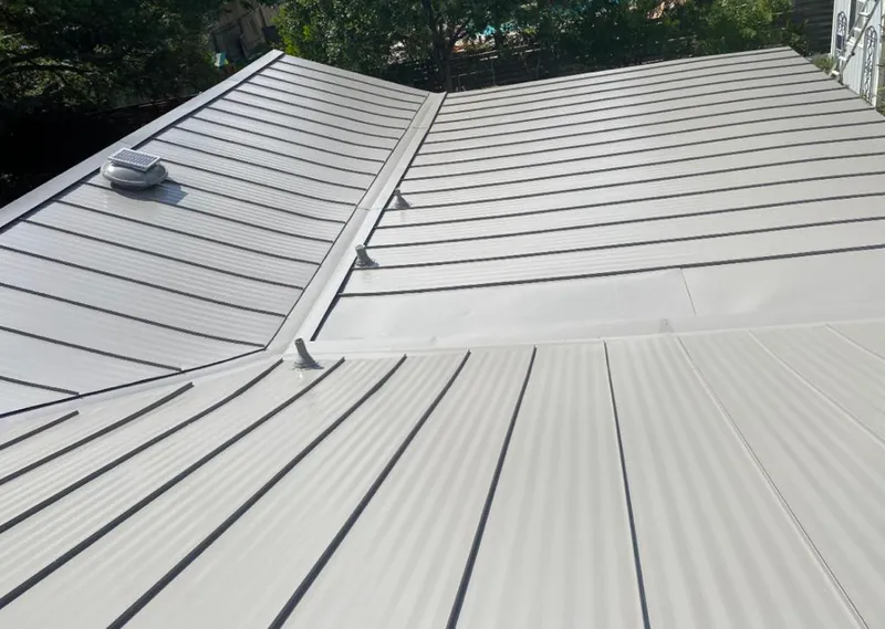Solar attic fan installed on a metal roof for Roof Ventilation in Stanford